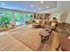 Open-concept living room with large windows, built-in bookshelves, and a plush sectional sofa at 307 Clayton Rd, Chapel Hill, NC 27514