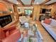 Open-concept living room with a brick fireplace, hardwood floors, and comfortable seating at 307 Clayton Rd, Chapel Hill, NC 27514