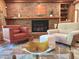 Inviting living room features a brick fireplace and stylish furniture, creating a cozy and elegant atmosphere at 307 Clayton Rd, Chapel Hill, NC 27514