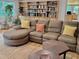 Spacious living room featuring a plush sectional sofa, bookshelves, and view of exterior trees at 307 Clayton Rd, Chapel Hill, NC 27514