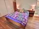 Cozy main bedroom featuring a wooden bed frame, bedside tables, and a colorful quilt at 307 Clayton Rd, Chapel Hill, NC 27514