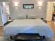Comfortable main bedroom featuring hardwood floors, neutral paint, ensuite and decorative lighting at 307 Clayton Rd, Chapel Hill, NC 27514