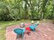 Outdoor patio with colorful chairs and a fire pit offers a relaxing space to enjoy the beautiful wooded backyard at 307 Clayton Rd, Chapel Hill, NC 27514
