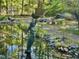 Water feature with Mermaid statue and lush landscaping creates a serene outdoor space at 307 Clayton Rd, Chapel Hill, NC 27514