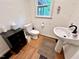 Clean and updated powder room with modern fixtures and vanity with black countertop at 307 Clayton Rd, Chapel Hill, NC 27514