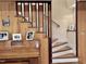 Staircase next to piano, featuring wooden accents, wall art, and white risers at 307 Clayton Rd, Chapel Hill, NC 27514