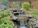Outdoor water feature with multiple cascades and beautiful stonework, creating a tranquil oasis at 307 Clayton Rd, Chapel Hill, NC 27514