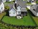 Aerial view of the home's backyard showcasing the patio area and expansive grassy space at 324 Prides Xing, Rolesville, NC 27571