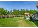 Expansive backyard with green grass, patio, and beautiful landscaping at 324 Prides Xing, Rolesville, NC 27571