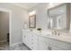 Bathroom featuring a double vanity with white cabinets and quartz countertop with marble tile floors at 324 Prides Xing, Rolesville, NC 27571