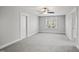 Large bedroom has neutral decor and carpet with bright windows at 324 Prides Xing, Rolesville, NC 27571
