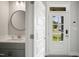 Well-lit entryway featuring a modern powder room and a door with glass panels at 324 Prides Xing, Rolesville, NC 27571