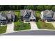 Aerial shot showcasing a modern home's front elevation, driveway, and well-manicured lawn at 324 Prides Xing, Rolesville, NC 27571