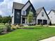 Charming two-story home with a two-car garage, manicured lawn, and beautiful blue and white color scheme at 324 Prides Xing, Rolesville, NC 27571