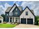 Charming two-story home with a two-car garage, manicured lawn, and beautiful blue and white color scheme at 324 Prides Xing, Rolesville, NC 27571