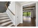Bright foyer with hardwood floors, white trim, and open staircase to the upper level at 324 Prides Xing, Rolesville, NC 27571