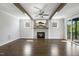 Bright living room with hardwood floors, fireplace, ceiling fan and access to the outdoor deck at 324 Prides Xing, Rolesville, NC 27571