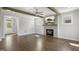 Bright living room with hardwood floors, fireplace, ceiling fan and access to the foyer at 324 Prides Xing, Rolesville, NC 27571