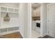 Mudroom with built-in storage leading to laundry room with modern washer and dryer at 324 Prides Xing, Rolesville, NC 27571