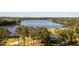 Scenic aerial view of the lake, surrounded by lush green trees and golf courses at 3258 Yorkshire Cir, Sanford, NC 27332