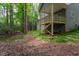House exterior with steps leading to a wood covered deck in a wooded setting at 3258 Yorkshire Cir, Sanford, NC 27332