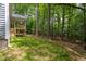 Backyard of a house with green grass and steps to the covered deck at 3258 Yorkshire Cir, Sanford, NC 27332
