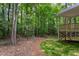 Secluded backyard with a view of the surrounding woods and a raised deck area at 3258 Yorkshire Cir, Sanford, NC 27332