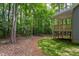Secluded backyard with a view of the surrounding woods and a raised deck area at 3258 Yorkshire Cir, Sanford, NC 27332