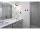 Elegant bathroom featuring double sinks, a large mirror, and a tiled shower at 3258 Yorkshire Cir, Sanford, NC 27332