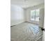 Bedroom featuring neutral walls and flooring, and natural light through a large window at 3258 Yorkshire Cir, Sanford, NC 27332