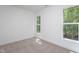 Bright, empty bedroom with neutral carpet and large windows offering a view of the trees at 3258 Yorkshire Cir, Sanford, NC 27332