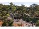 Aerial view of the clubhouse surrounded by lush greenery, with golf carts lined up in the parking area at 3258 Yorkshire Cir, Sanford, NC 27332