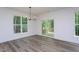 Chic dining room with backyard views and modern chandelier with backyard deck access at 3258 Yorkshire Cir, Sanford, NC 27332