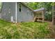 The exterior of a home shows the stairs that lead up to a deck at 3258 Yorkshire Cir, Sanford, NC 27332