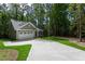 Charming home with a two-car garage and a driveway surrounded by trees and lush grass at 3258 Yorkshire Cir, Sanford, NC 27332