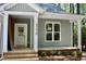 Welcoming entrance with covered porch, classic white trim, and a bright front door at 3258 Yorkshire Cir, Sanford, NC 27332