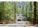 Scenic exterior view of a new home nestled in a tranquil wooded setting with a concrete driveway at 3258 Yorkshire Cir, Sanford, NC 27332