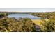 Picturesque lake view with lush greenery and a glimpse of a golf course fairway and sand trap at 3258 Yorkshire Cir, Sanford, NC 27332