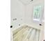 Bright laundry room featuring modern flooring and a window with a view of the outdoors at 3258 Yorkshire Cir, Sanford, NC 27332