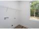 Laundry room featuring modern flooring, utility connections, and window with outdoor views at 3258 Yorkshire Cir, Sanford, NC 27332