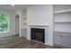 Comfortable living room featuring a fireplace, built-in shelves, cabinets and large window at 3258 Yorkshire Cir, Sanford, NC 27332