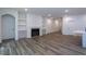 Spacious living room featuring a fireplace, built-in shelves and lots of natural light at 3258 Yorkshire Cir, Sanford, NC 27332