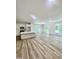 Open-concept living space with a kitchen island, bright windows, and access to the backyard at 3258 Yorkshire Cir, Sanford, NC 27332
