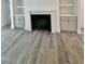 Cozy living room with a fireplace, built-in cabinets, and neutral color palette at 3258 Yorkshire Cir, Sanford, NC 27332