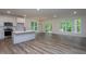 Open-concept living space featuring wood floors, white walls, lots of natural light, and deck access at 3258 Yorkshire Cir, Sanford, NC 27332