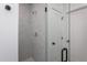Modern tiled shower with glass door and brushed metal shower fixtures at 3258 Yorkshire Cir, Sanford, NC 27332