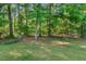 Wooded backyard offering a serene and private outdoor space at 35 Stonewall Way, Durham, NC 27704