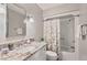 Modern bathroom featuring a white vanity, granite countertop, and shower-tub combo at 35 Stonewall Way, Durham, NC 27704
