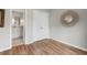 A bedroom with a connecting door to the bathroom and modern wood-look flooring at 35 Stonewall Way, Durham, NC 27704