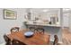 Dining room with wood table, chairs, and bar seating overlooking kitchen at 35 Stonewall Way, Durham, NC 27704